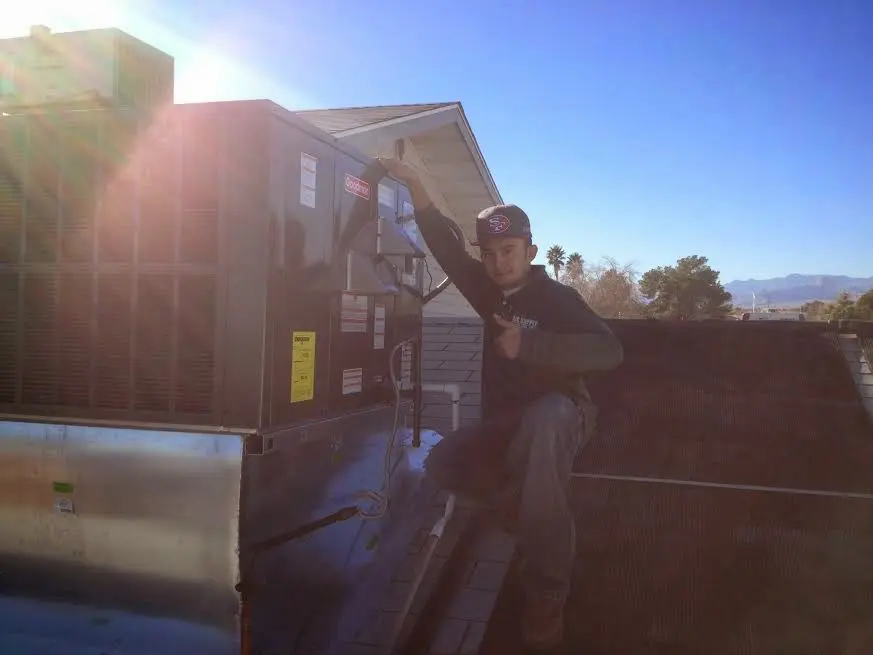 HVAC technician performing HVAC Inspection on a rooftop unit in East Brunswick